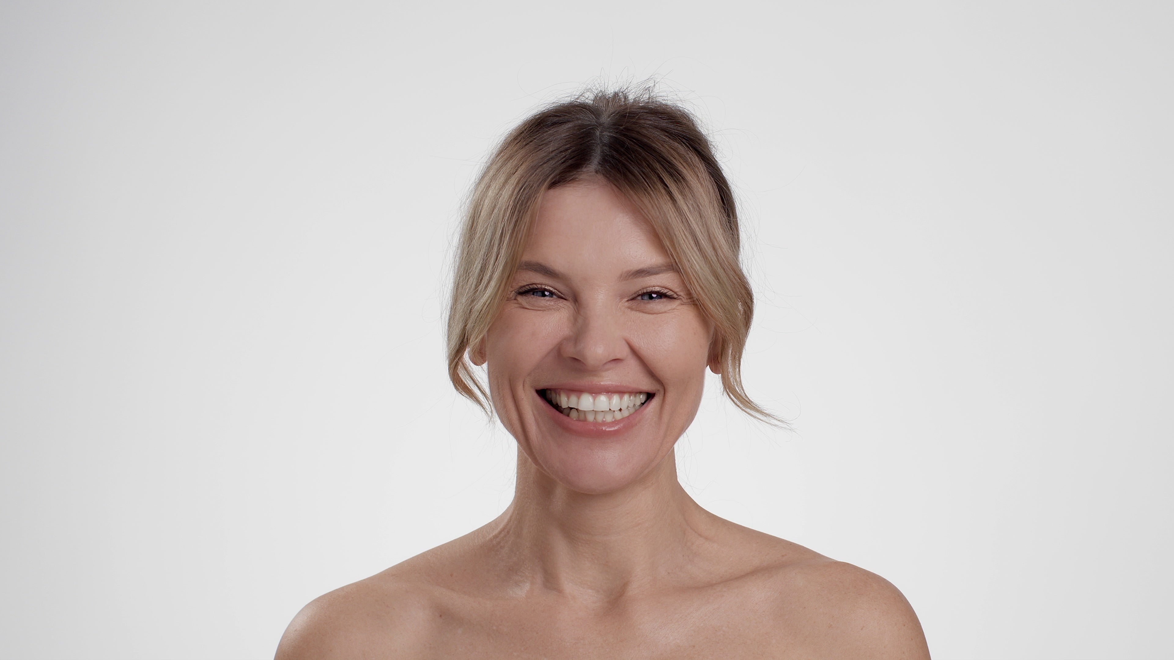 files/happy-aging-carefree-middle-aged-woman-with-bare-shoulders-laughing-to-camera-white-st-SBI-350026799.jpg